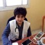 Dr. Raid's son helping on a medical treatment day.